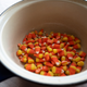 A photo of candy corn in the bottom of an enameled sauce pan.